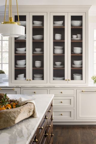 a large kitchen cabinet with dishes on display