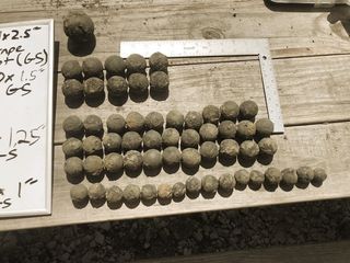 Examples of different sizes of canister and grapeshot recovered in Congaree River cleanup project.
