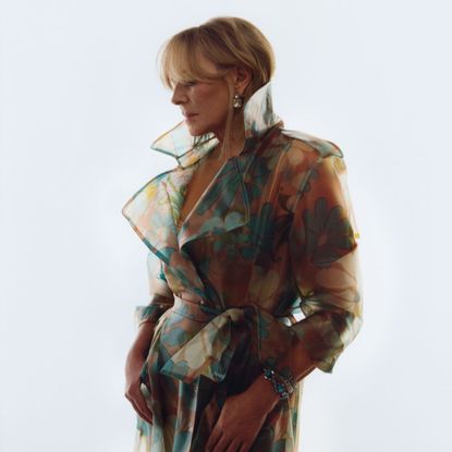 kim cattrall poses in a sheer trench coat for the new designers at debenhams x ashish campaign