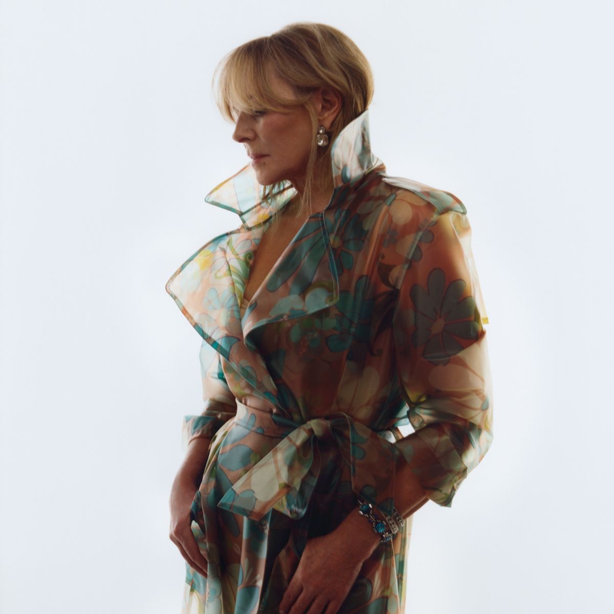 kim cattrall poses in a sheer trench coat for the new designers at debenhams x ashish campaign
