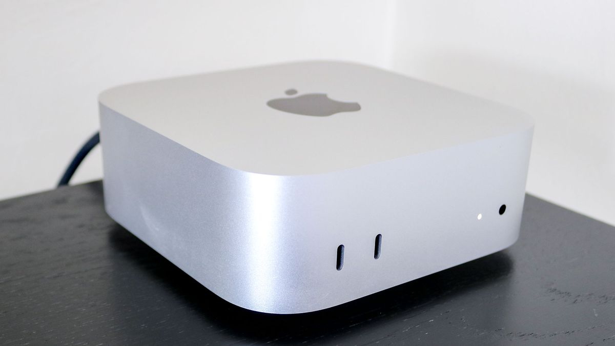 The Mac mini M4 on top of a desk riser shelf