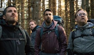 The Ritual guys standing in the woods, looking at something stunned
