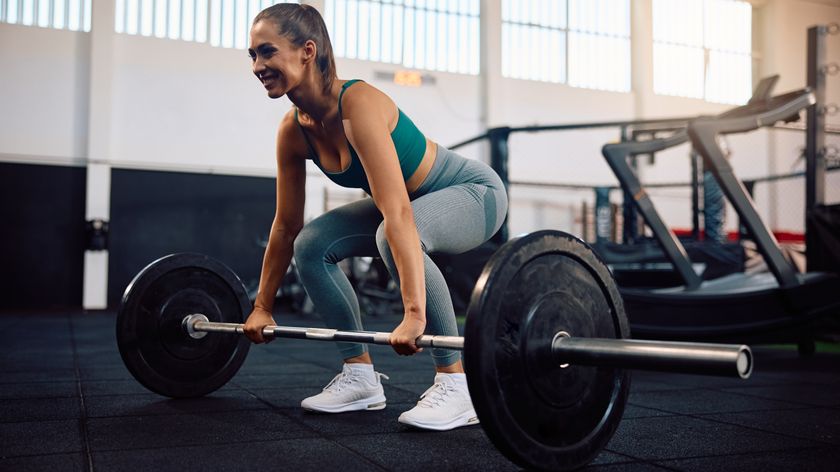 a woman doing a barbell deadlift