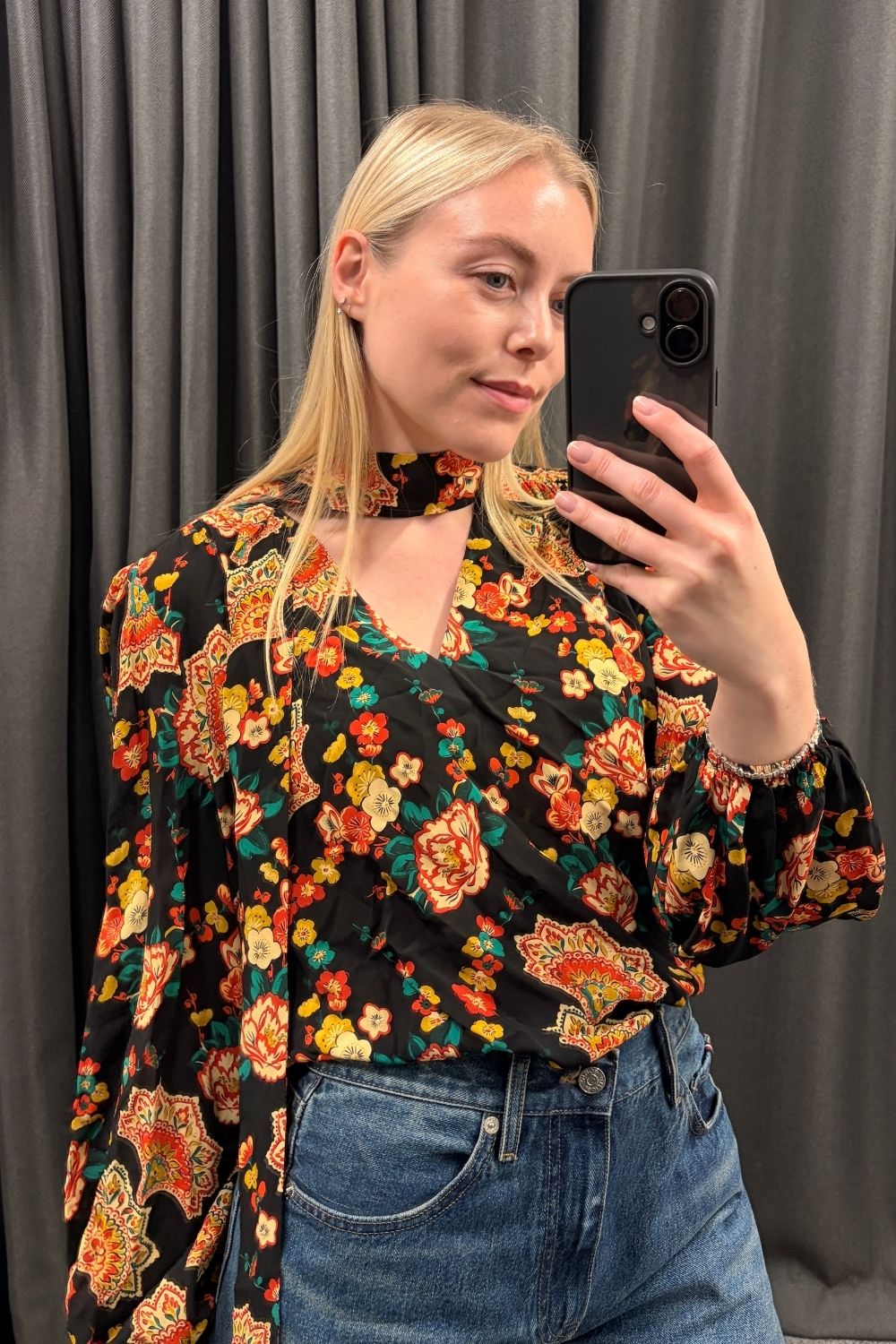 Florrie wears a printed blouse and blue jeans from the John Lewis X Rixo collaboration