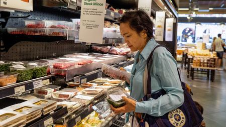 A customer choosing products at a UK supermarket