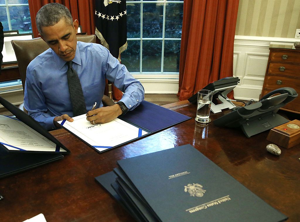 Obama signing a bill