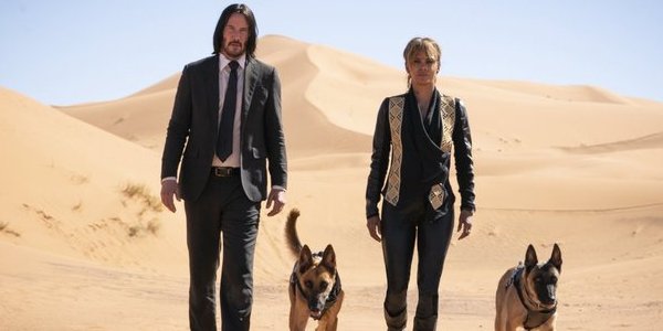 John Wick: Chapter 3 - Parabellum Keanu Reeves and Halle Berry walking the desert with two dogs