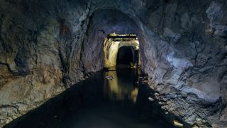 An abandoned, flooded mine that is slightly lit