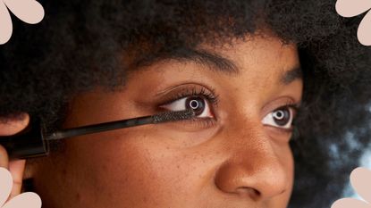 A woman applying mascara to her lower lashes to iliustrate what is tubing mascara