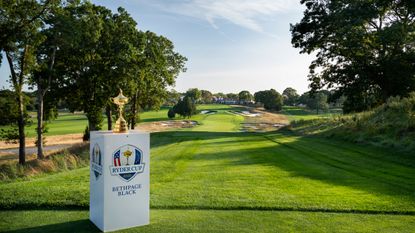 The Ryder Cup trophy stands in front of the first tee at Bethpage Black