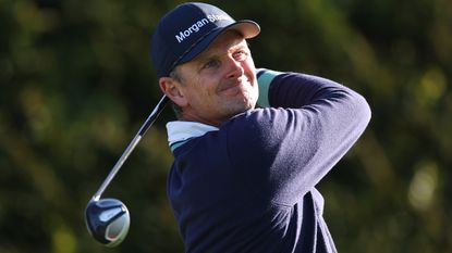 Justin Rose holds his finish after a fairway wood shot