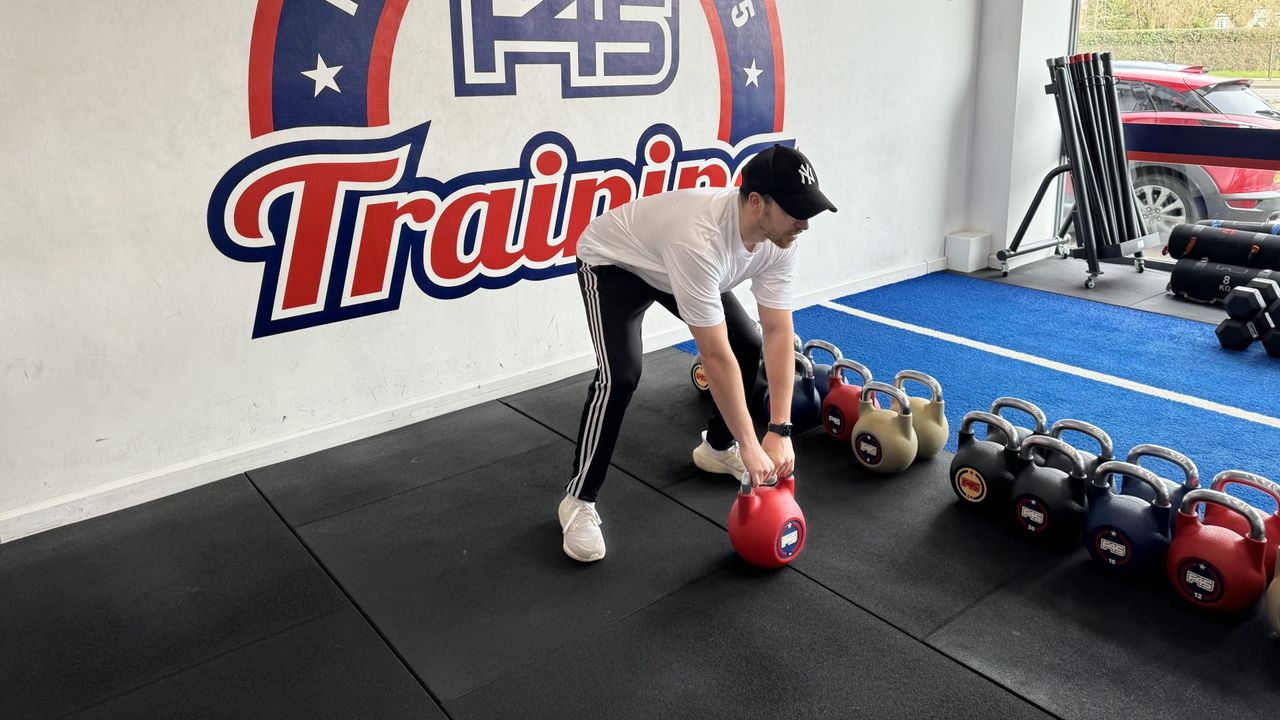 F45 personal trainer demonstrates a kettlebell swing