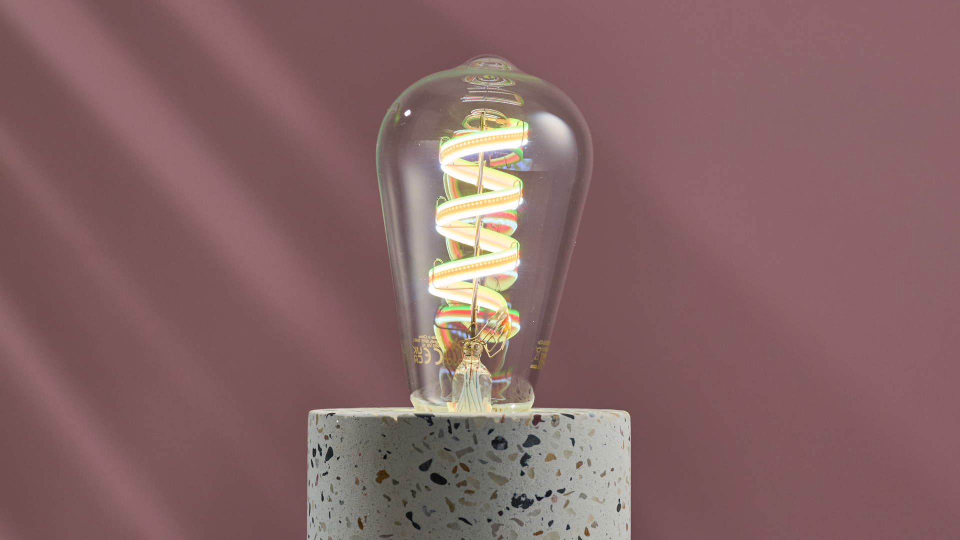 The WiZ filament bulb is lit up green.