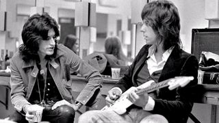 Joe Perry (left) and Jeff Beck chat backstage at The Providence Civic Center on October 7, 1976 
