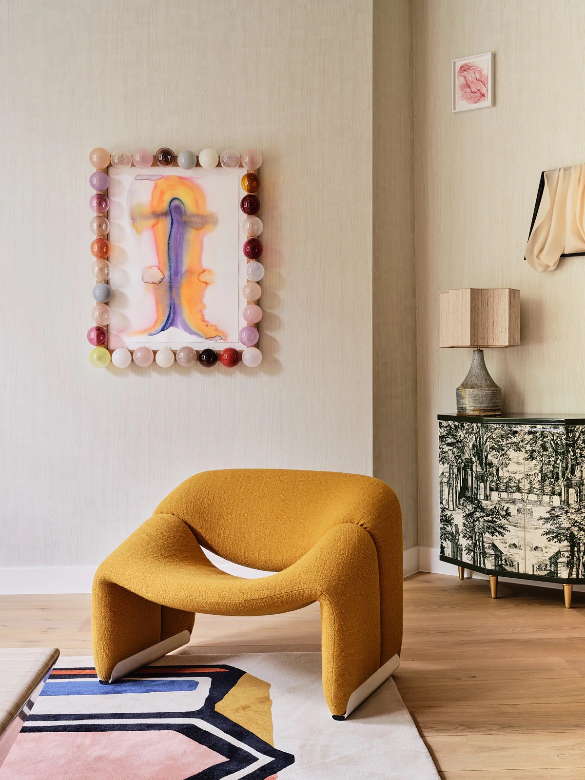 A neotenic living room with sculptural yellow armchair and playful decoration