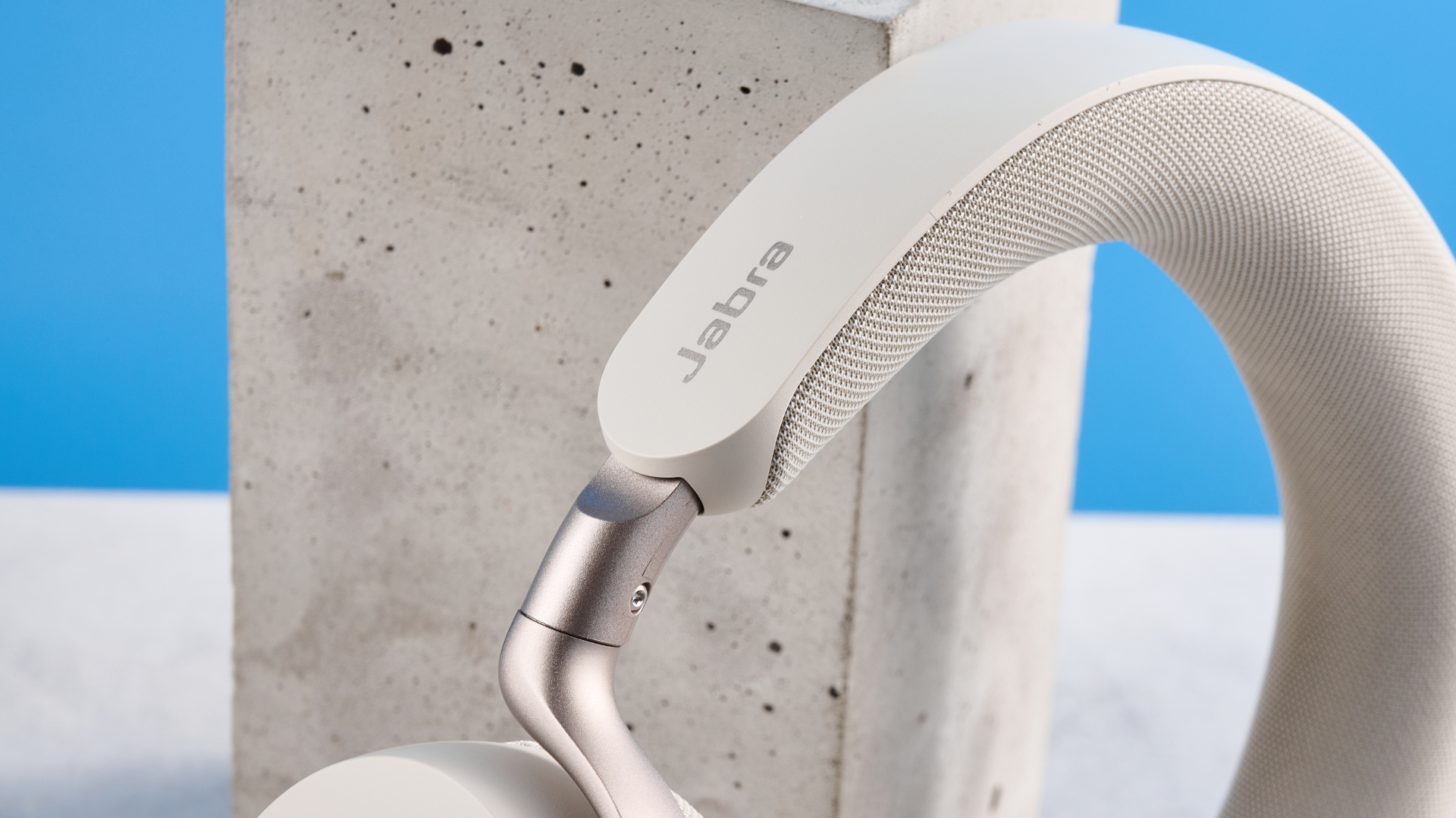 Jabras Evolve3 75 conferencing headset on a stone surface with a blue background