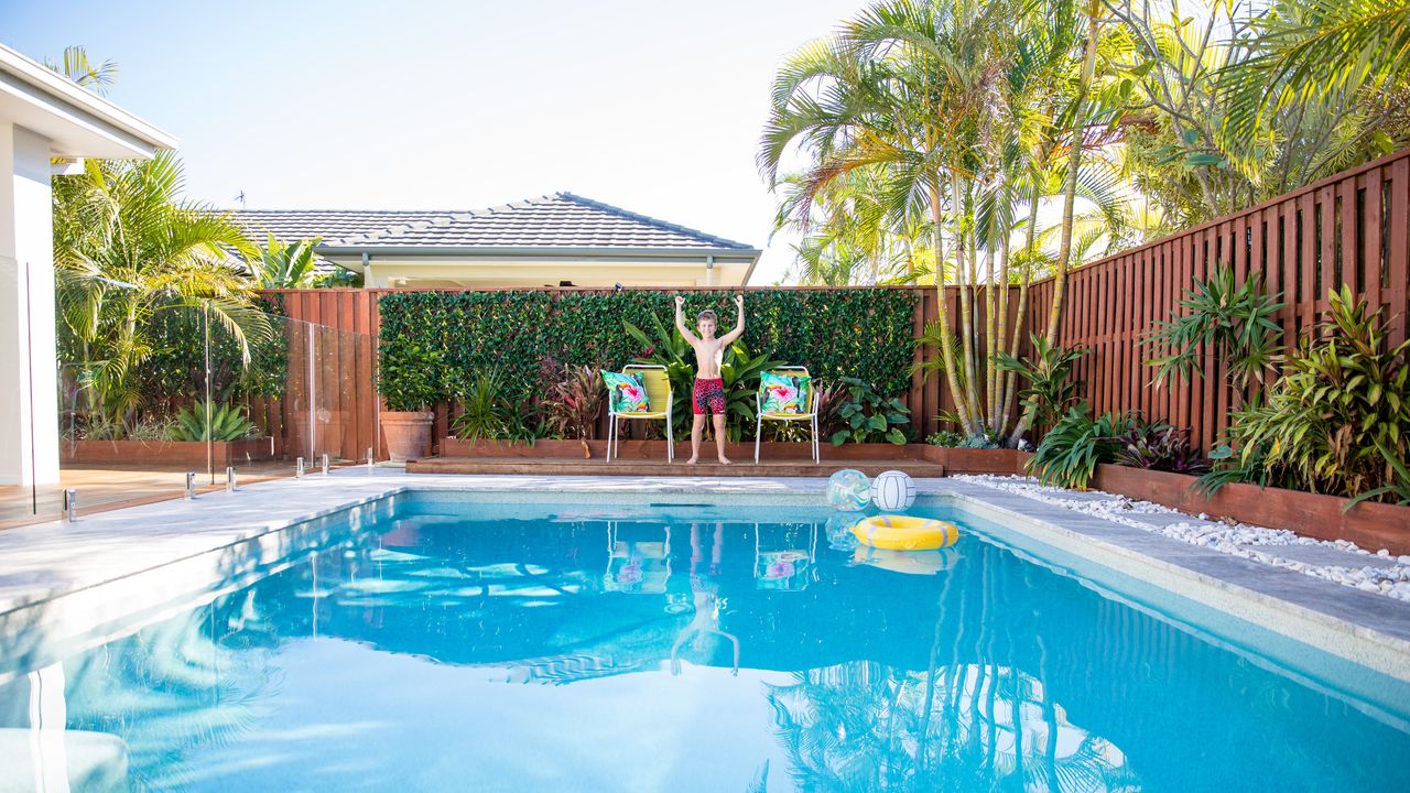 pool fence ideas: backyard pool with glass and wooden fences