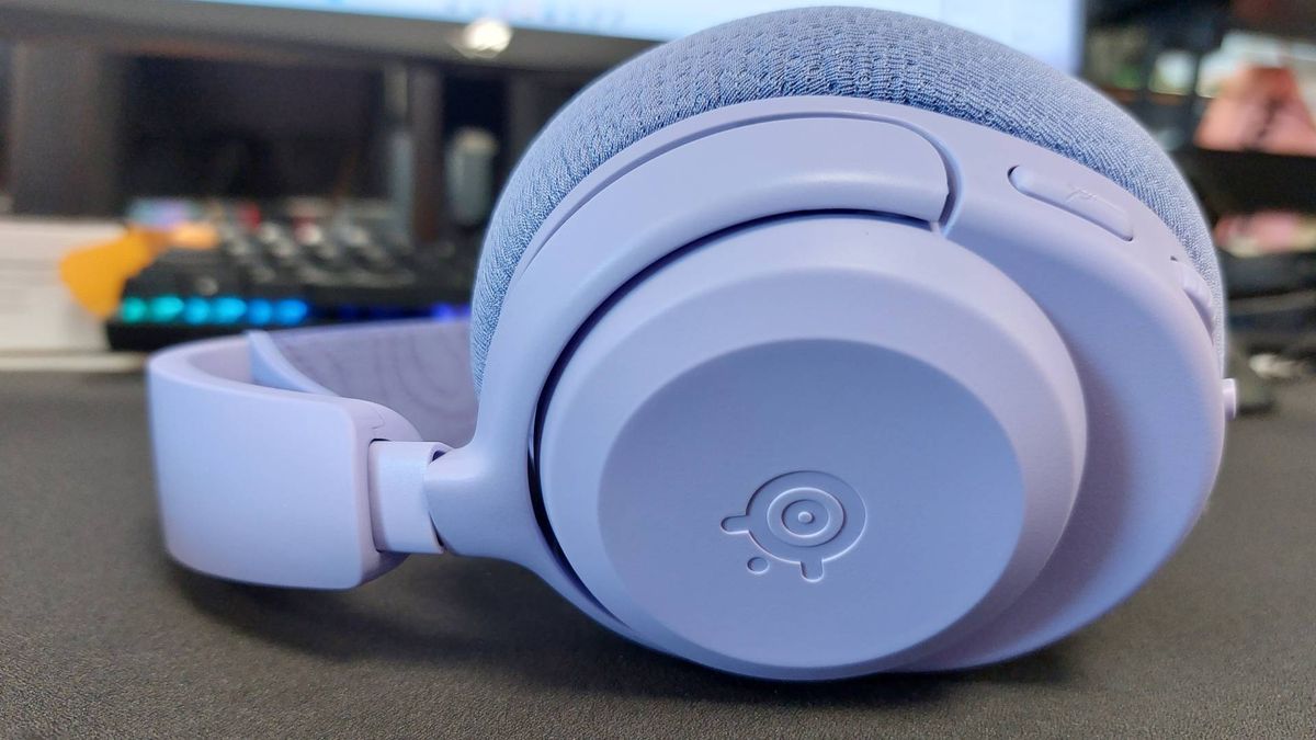 The SteelSeries Arctis Nova 3 X seen on a desk. This is the Lavender colourway.