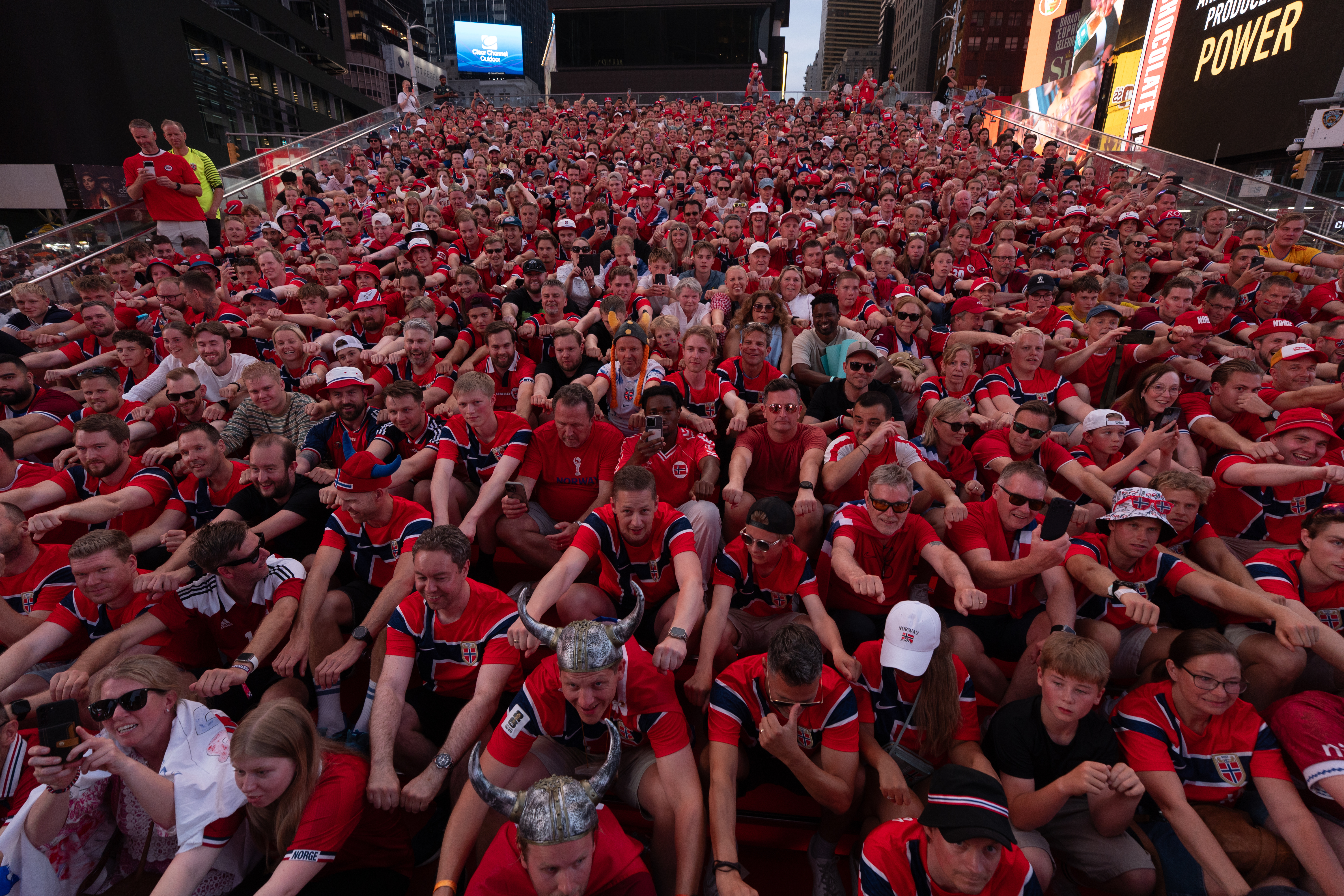 NEW YORK, UNITED STATES - JUNE 21: Norwegian national football team supporters gather on the iconic red steps in Times Square ahead of Monday&amp;amp;apos;s FIFA World Cup match, creating a festive atmosphere with chants and traditional rowing celebrations as fans dressed in red and waving flags filled the famous Manhattan landmark in New York, United States on June 21, 2026. (Photo by Lokman Vural Elibol/Anadolu via Getty Images)
