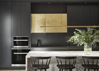 colors that go with black with back storage complemented with gold-fronted cabinet, and a white island