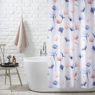 bathroom with white bricked wall and floral curtain and bathtub