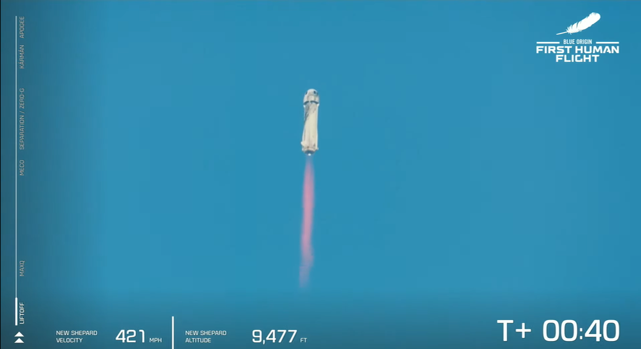 The first crewed New Shepard rocket blasts off on July 20, 2021.