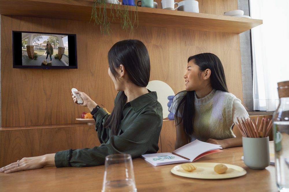 Two people using the Chromecast to watch TV