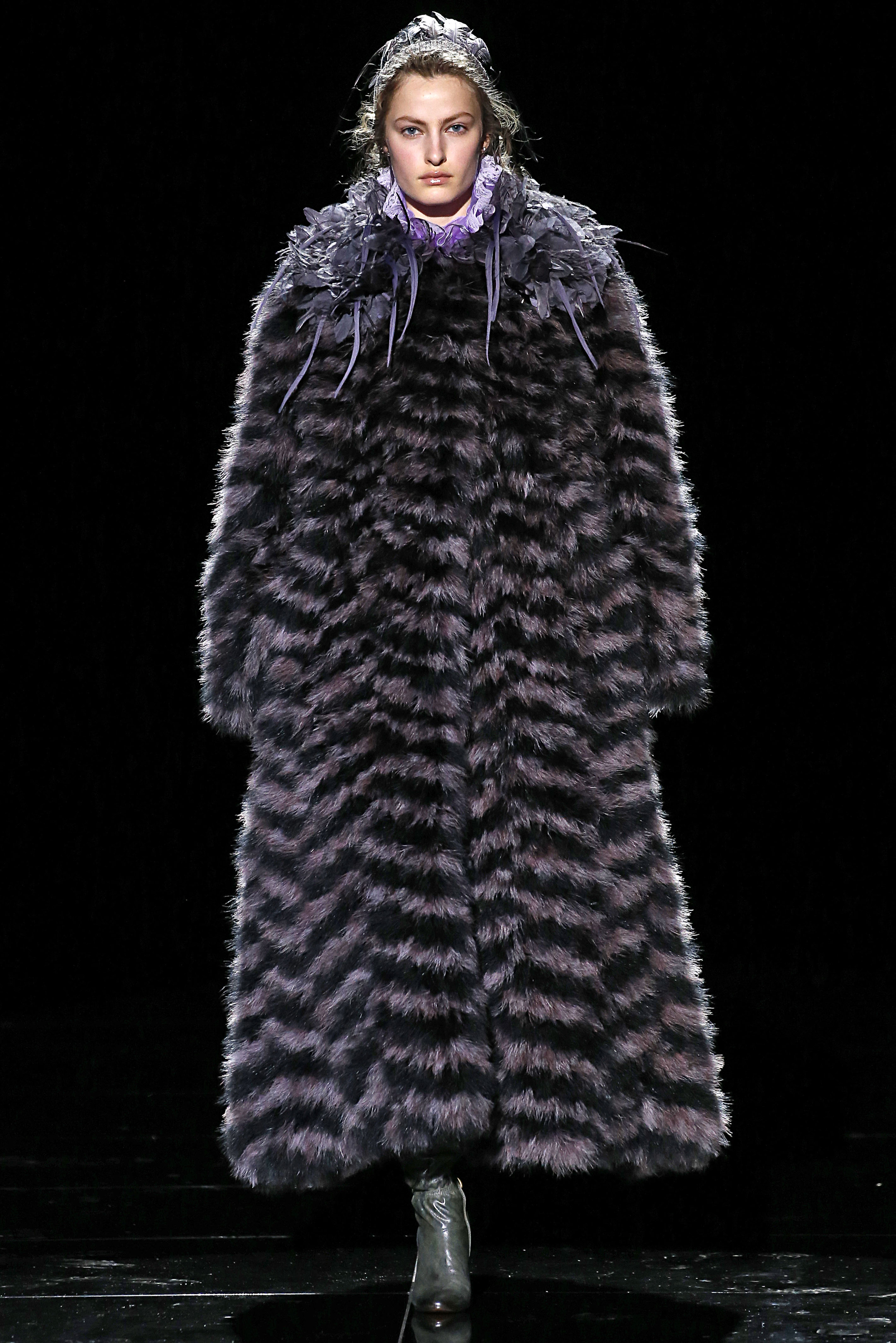 a model wearing a long fur coat at marc jacobs