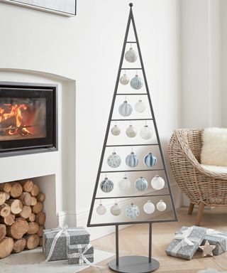 Grey metal Christmas tree with rows of baubles