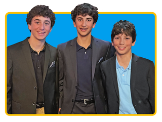 Image of three young boys, Seeliger brothers, with a blue background