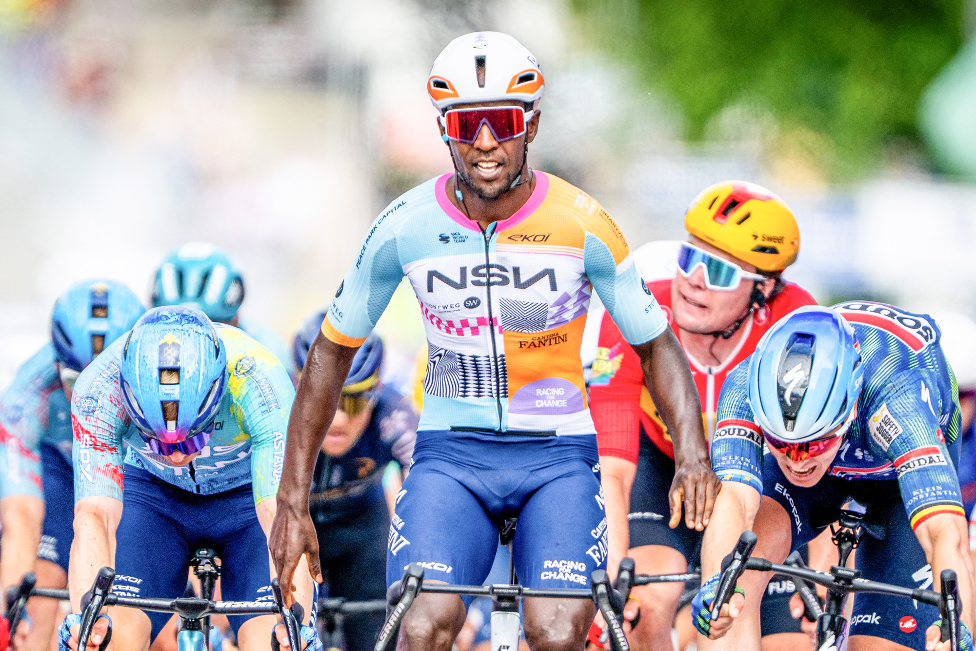 NSN Cycling Team's Eritrean rider Biniam Girmay (C) celebrates as he crosses the finish line ahead of Soudal Quick-Step's Belgian rider Tim Merlier (2nd R) to win the 1st stage of the Tour of Belgium cycling race, 187.9 km starting and finishing in Scherpenheuvel-Zichem, on June 17, 2026. The Belgium Tour takes place from 17 to 21 June. (Photo by JASPER JACOBS / Belga / AFP via Getty Images) / Belgium OUT
