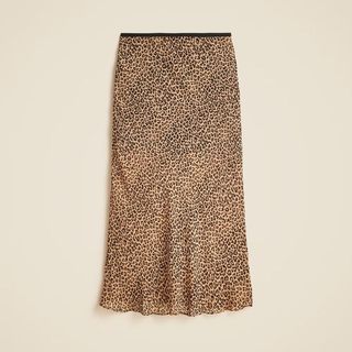 A cutout of a leopard print skirt against a beige background