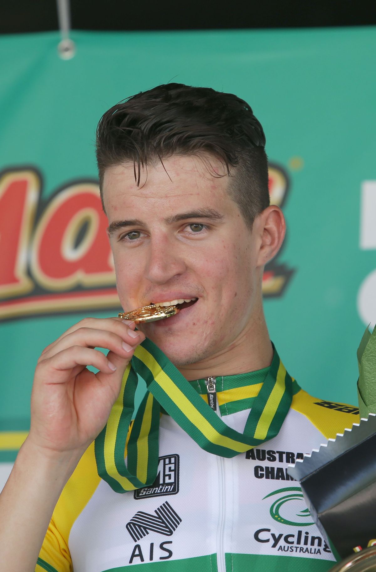 Miles Scotson bites his gold medal