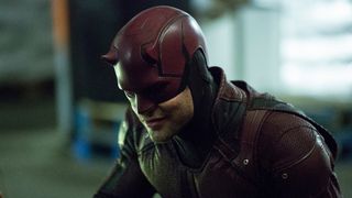 Charlie Cox as Daredevil smirking during a scene in the Netflix series Daredevil.