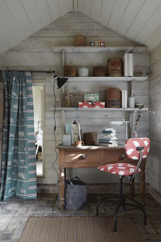 Craft room with open shelving and a swivel chair