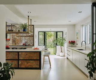 White kitchen with a metallic kitchen island