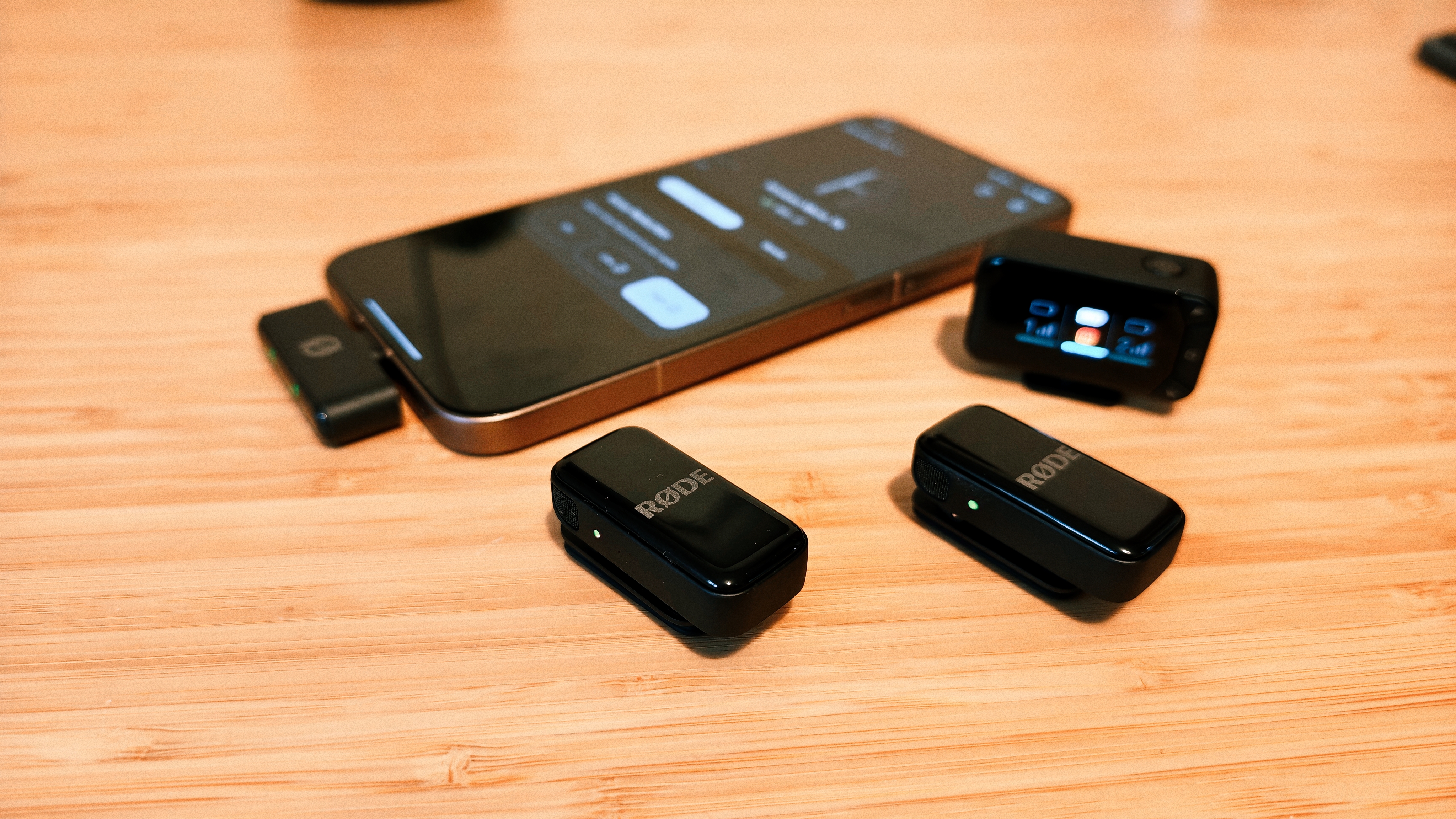 A Rode Wireless Micro Camera Kit on a wooden desk