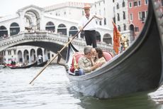 A couple on a boat ride in Venice.