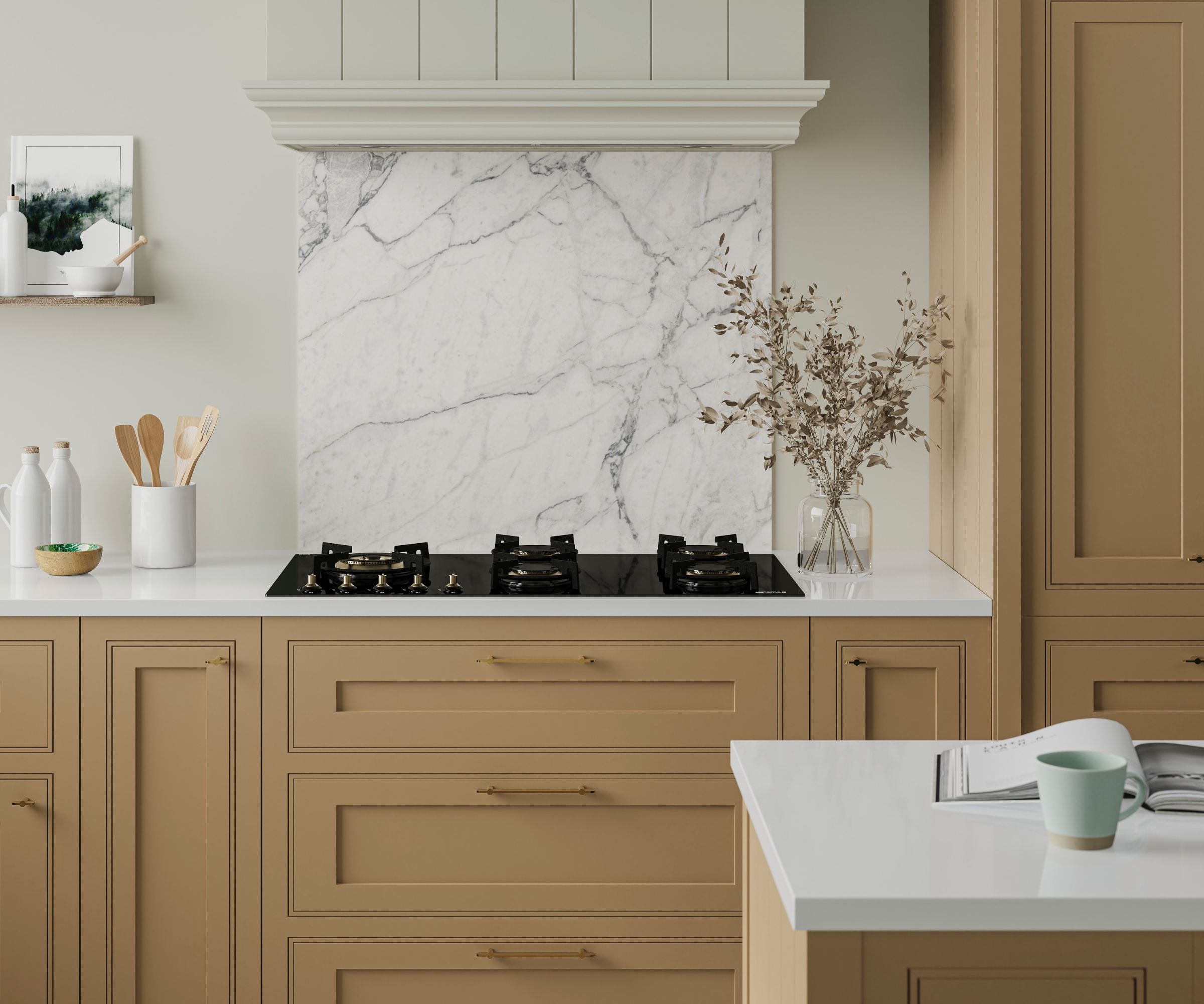 An elegant kitchen with warm sand-toned shaker cabinets and brass bar handles, centred around a large slab marble splashback with grey veining behind a black four-burner gas hob. A cream panelled chimney hood, white quartz worktop and dried stem arrangement complete the refined, neutral scheme.