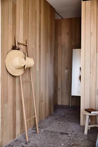 Oak slated walls with bamboo ladder and wicker hat