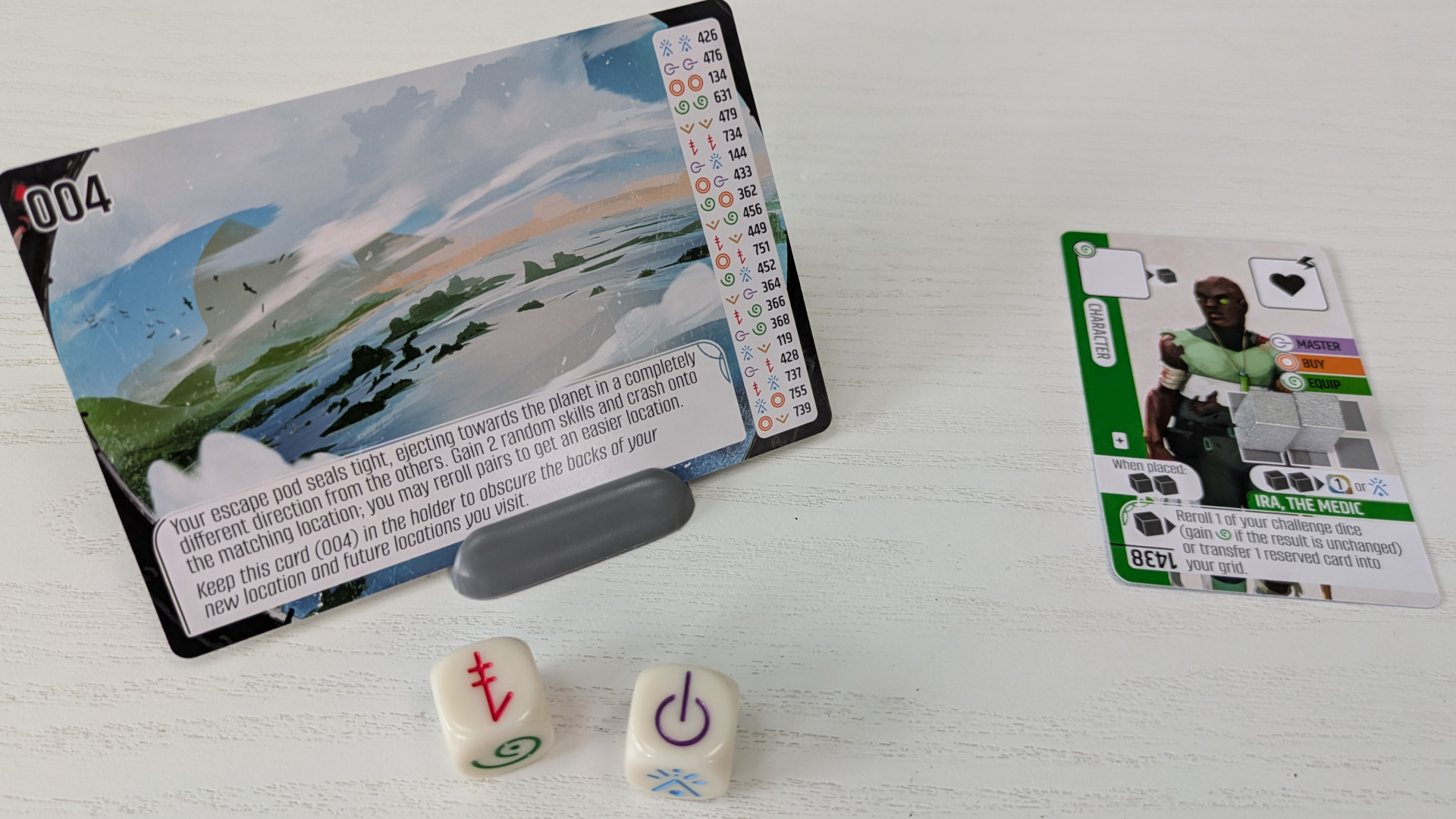 Vantage cards and dice laid out on a white wooden surface