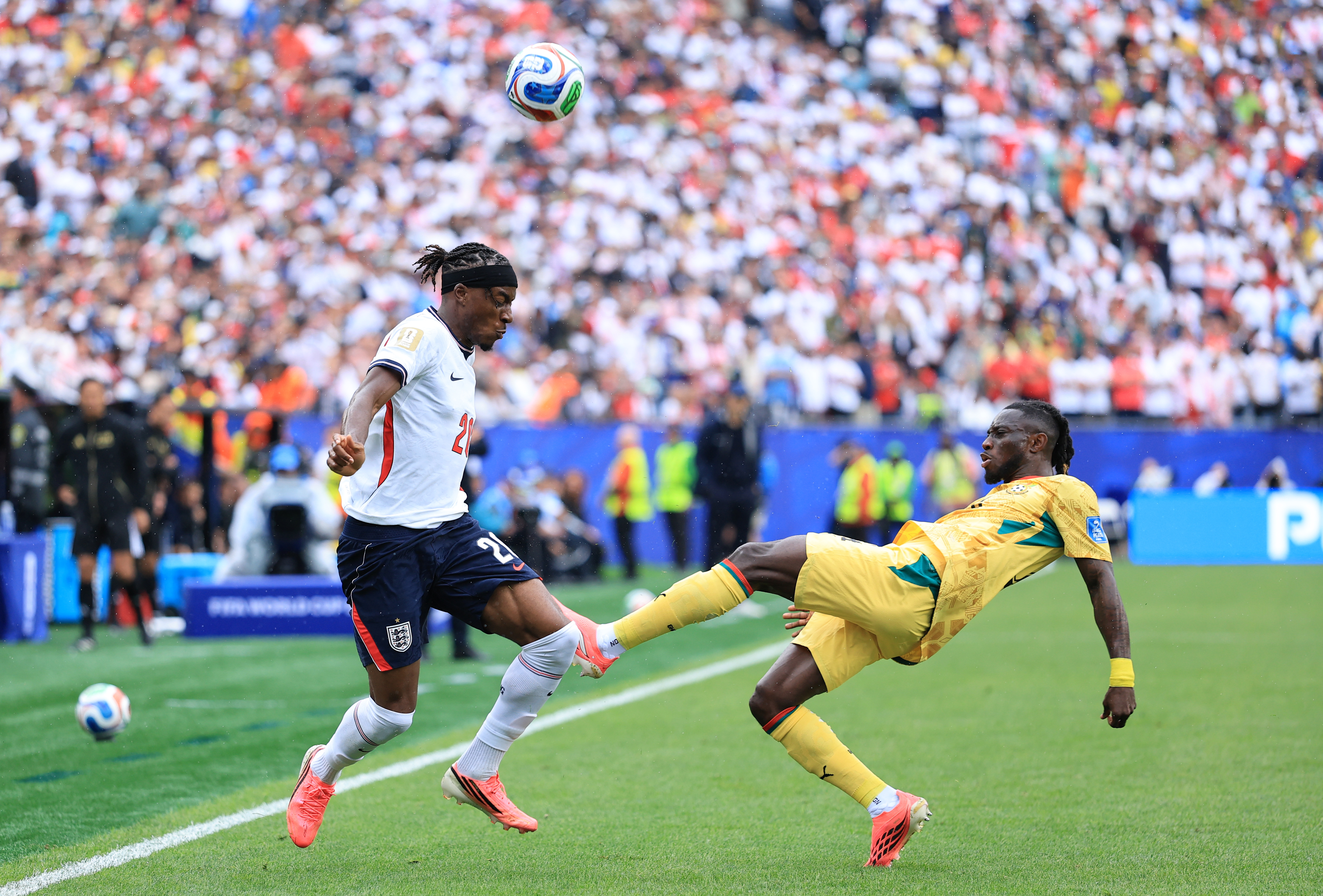 Noni Madueke vs Ghana, Ghana player lunges into a tackle against Madueke.