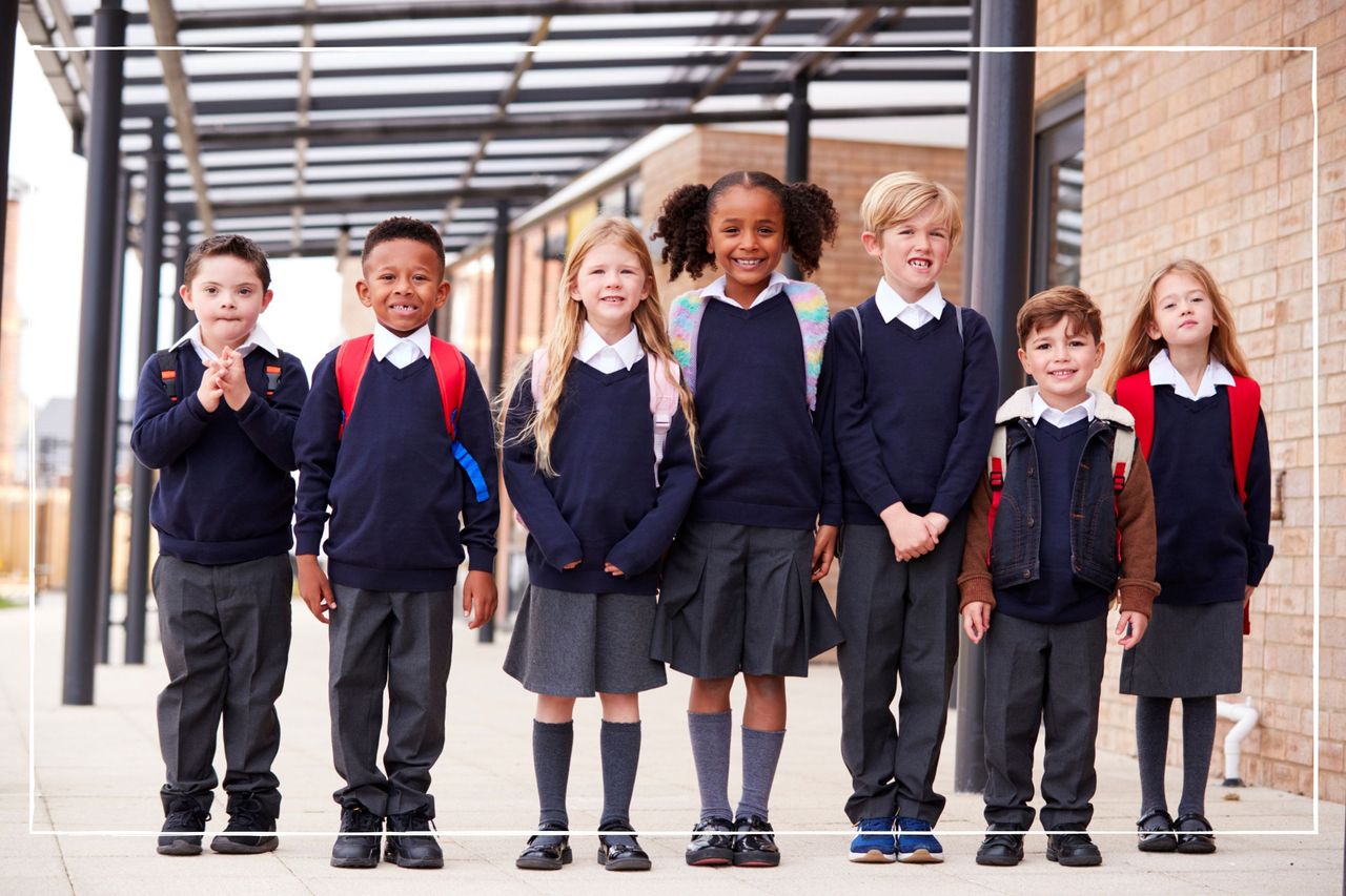 Group of kids in school uniform with backpacks on walking towards the camera