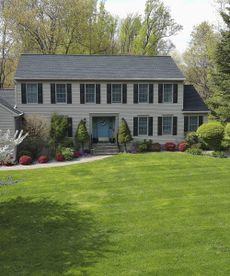 A green front lawn outside a two-storey house