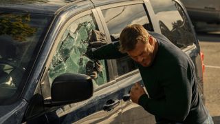 Jack Reacher (Alan Ritchson) punches through a minivan window in Reacher season 2 episode 1