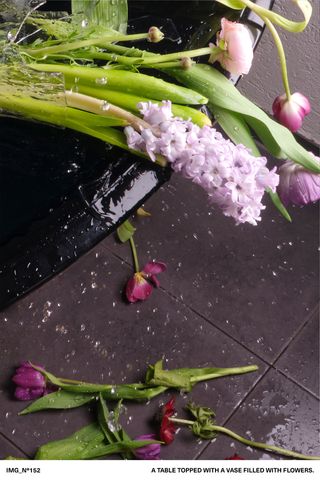 Smashed vase of flowers on table