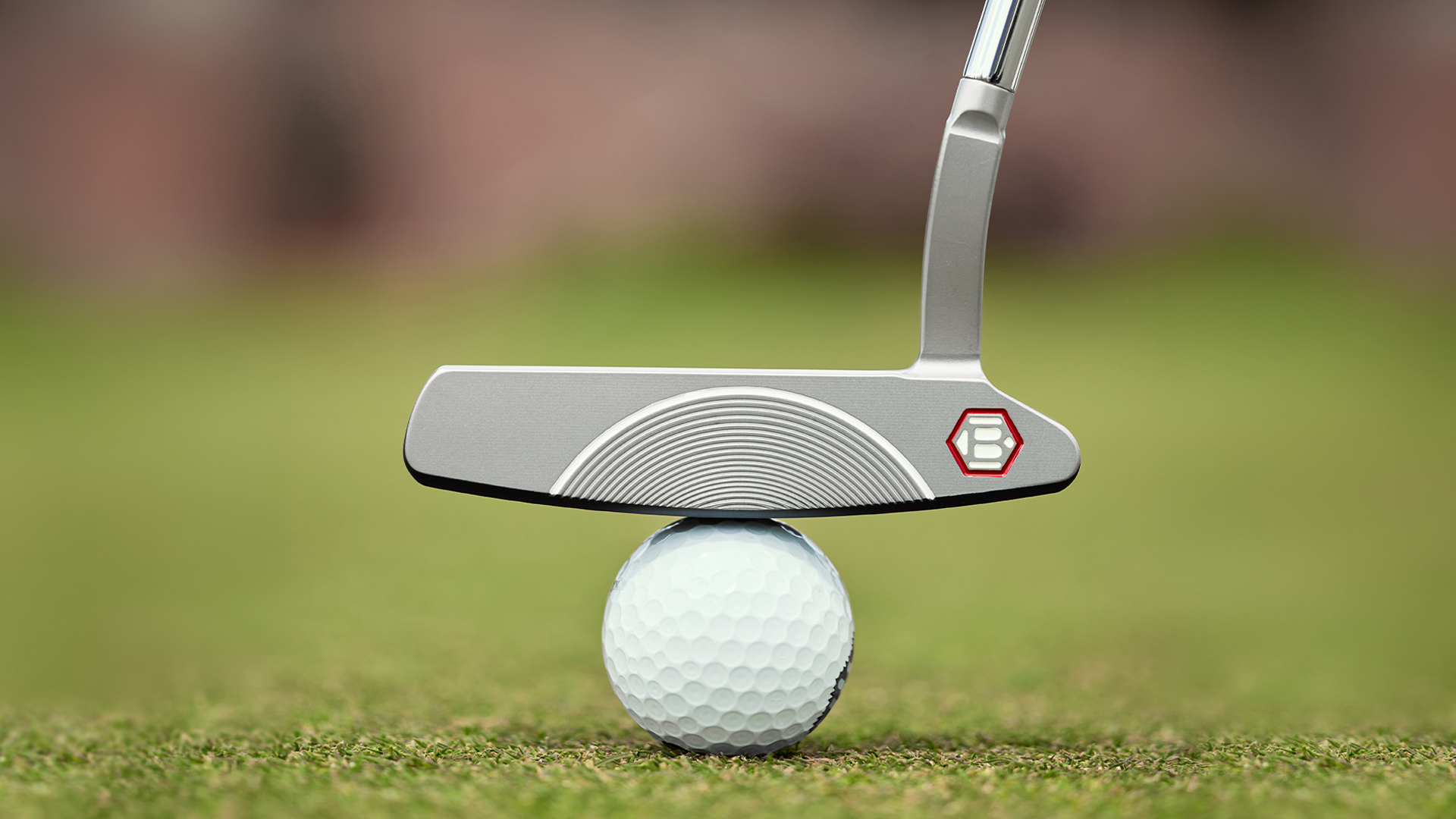 A close-up of a Bettinardi putter resting on a golf ball