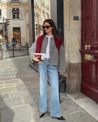 French woman wearing a gray jacket and jeans in Paris