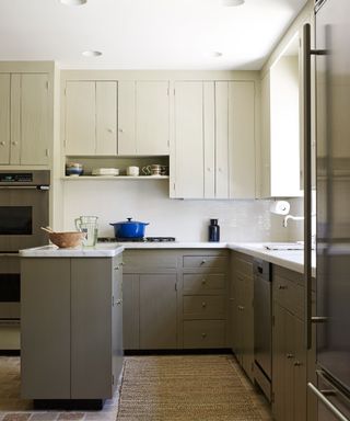 A u-shaped kitchen with a peninsula and cabinets in neutral tones