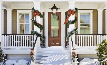 Snowy front porch decorated for Christmas